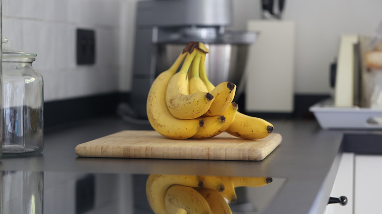 A bunch of bananas sitting on a shiny countertop