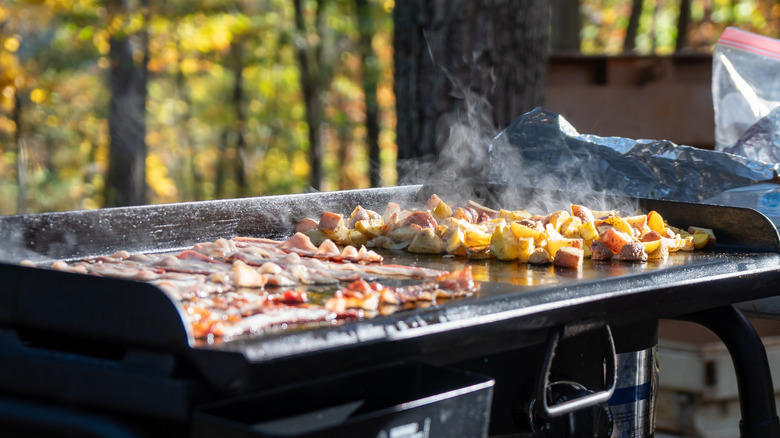 person cooking on griddle outdoors