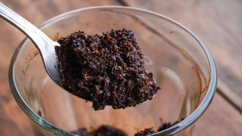 a spoonful of used coffee grounds