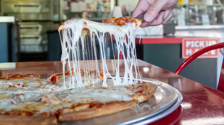 slice of pizza out of pie at gas station