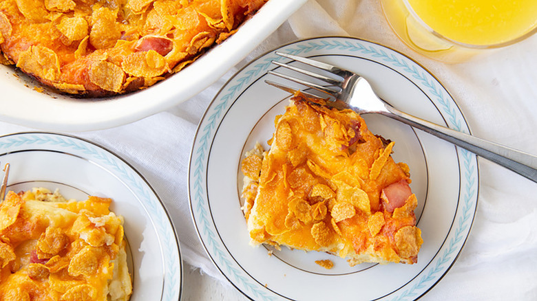 Portion of cornflake-topped ham and cheese strata on plate