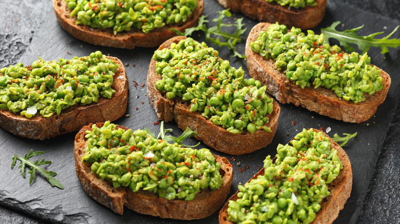 Smashed peas on slices of sourdough toast