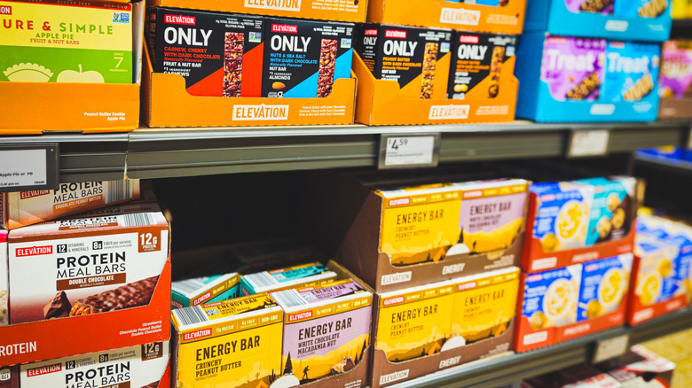 Different Aldi brand protein bars stacked on shelves