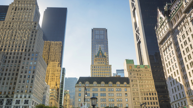 shot of new york city's the plaza hotel with other skyscrapers by it
