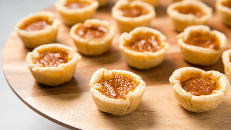 mini pumpkin pies on board