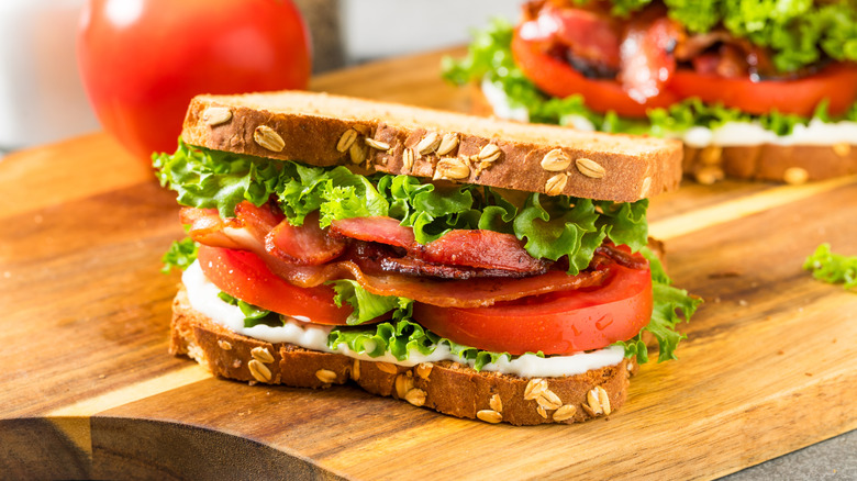 A BLT sandwich on a wooden cutting board