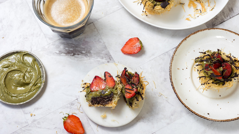 Dubai chocolate strawberry cup cut in half on small plate