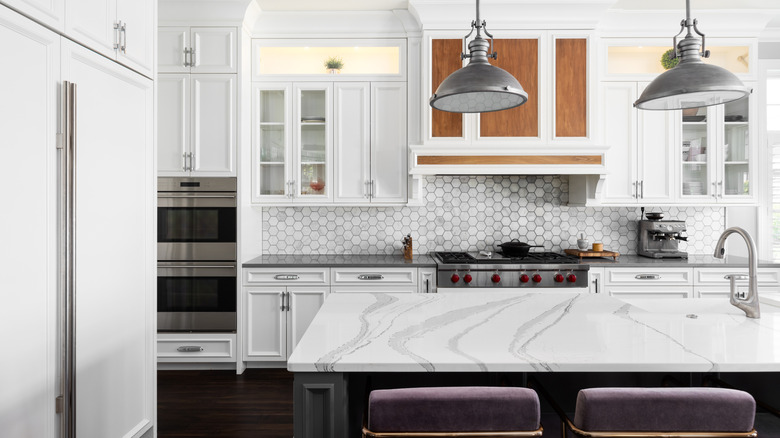 White kitchen with marbled countertop and backsplash