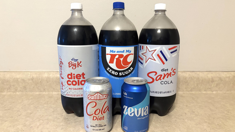 A variety of diet sodas on a neutral background