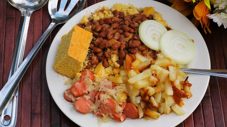 Plate of Appalachian delicacies including onion, cornbread, and pinto beans