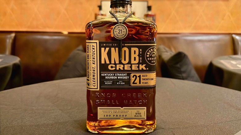 A bottle of Knob Creek 21 Year bourbon on a table