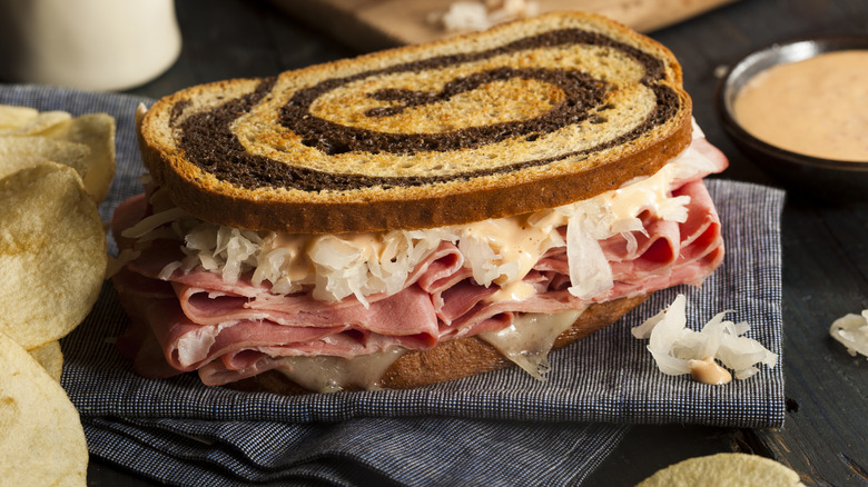 Close-up of a Reuben sandwich with potato chips