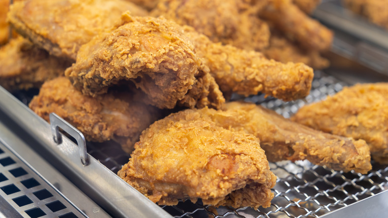 Crispy chicken tenders steaming on a fryer basket