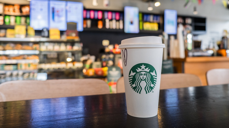 starbucks cup on counter in store