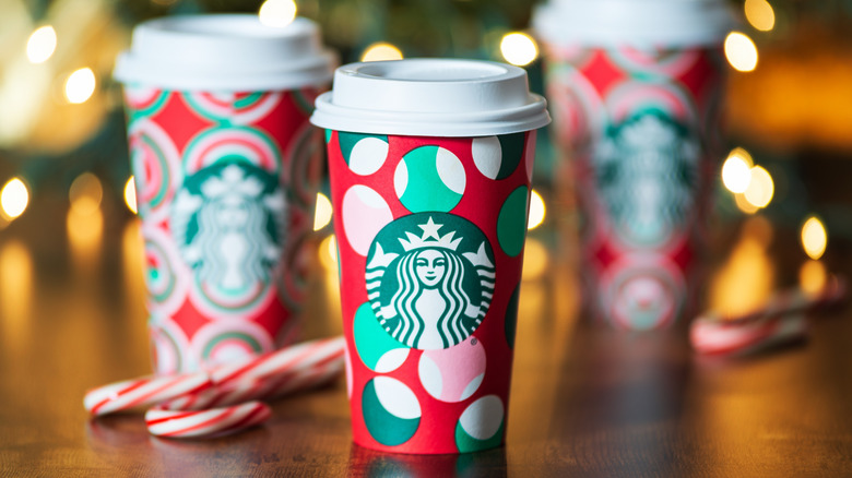 A trio of red Starbucks holiday cups