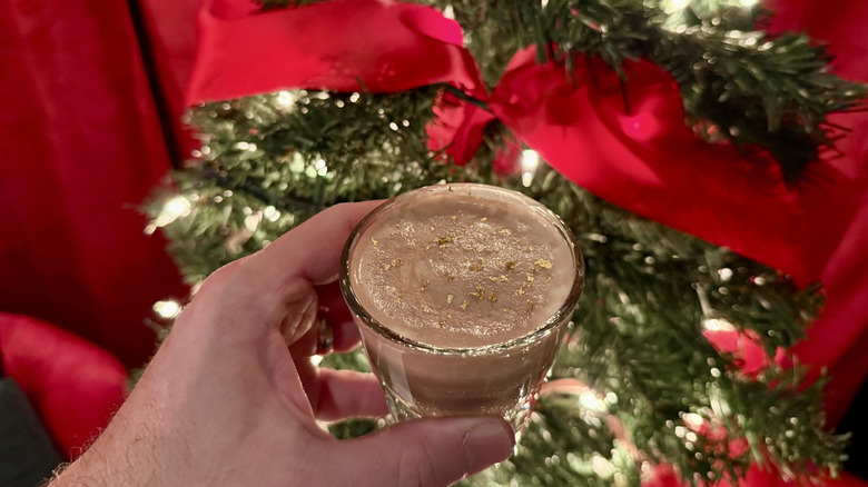 Caramel miso hot cocoa in front of a Christmas tree