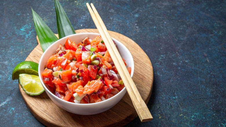 Bowl of lomi lomi salmon with chopsticks