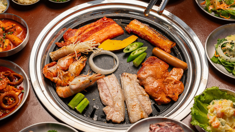 Korean BBQ grill with various cuts of meat