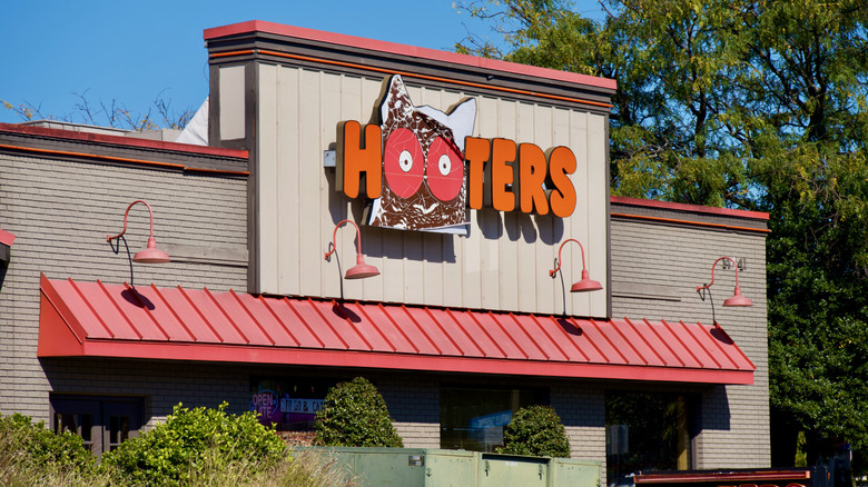 The brightly lit exterior of a Hooters location