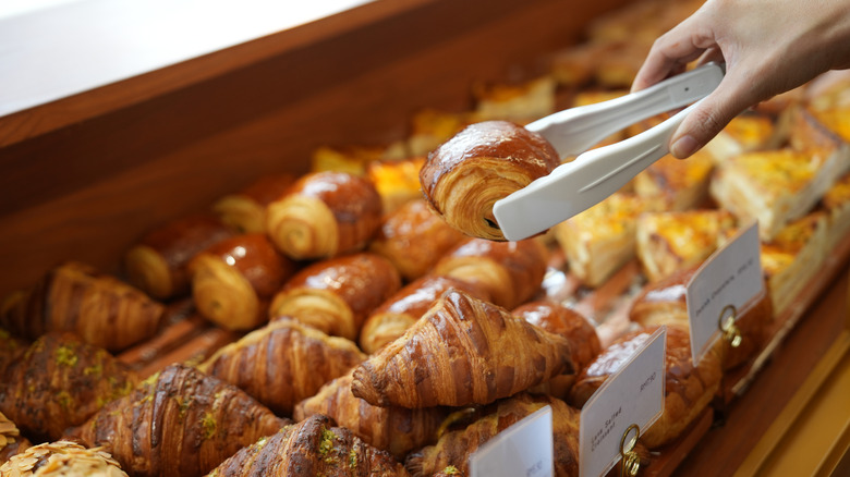 selection of pastry items with person picking out one