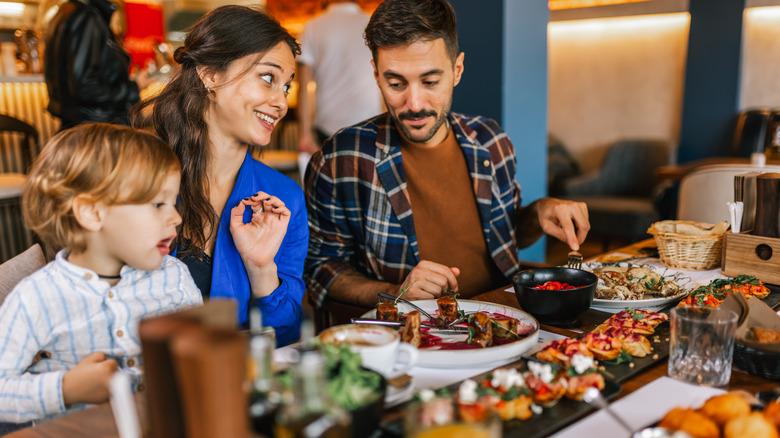 Family of three dining at a restaurant