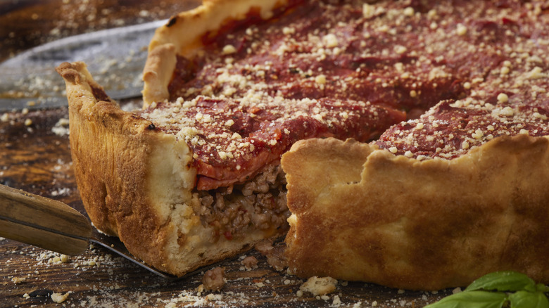 Slice being taken out of deep dish pizza