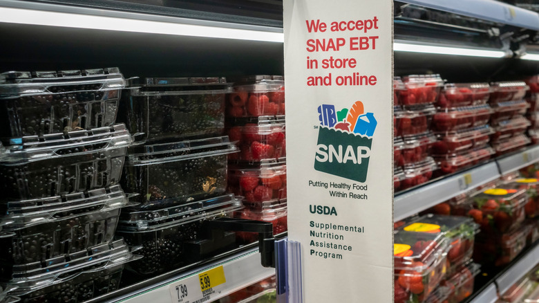 A window with stickers explaining the acceptance of SNAP benefits