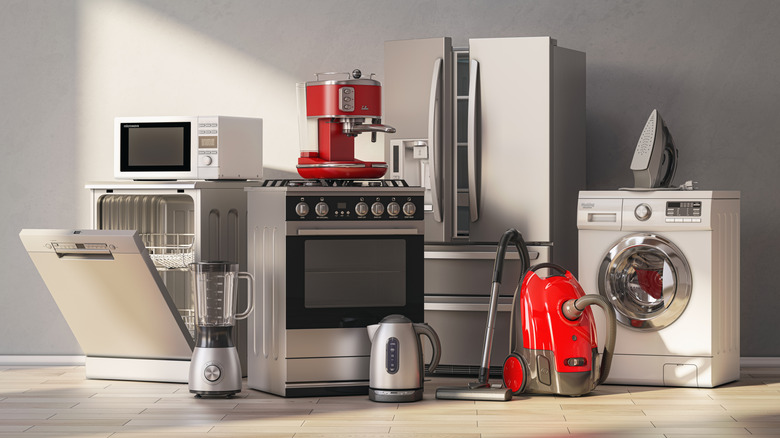 Various silver or red home appliances in gray room