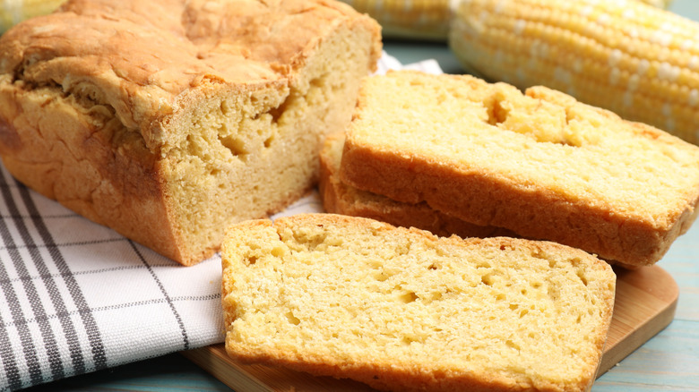 Cornbread cut in slices with cob and kitchen towel
