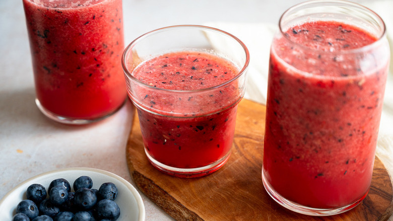 Watermelon blueberry cocktail in glasses next to a bowl of fresh blueberries