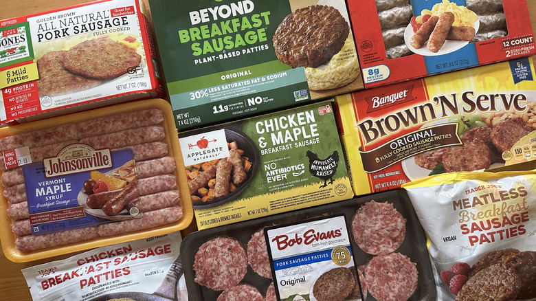 Variety of breakfast sausage packages on wooden table