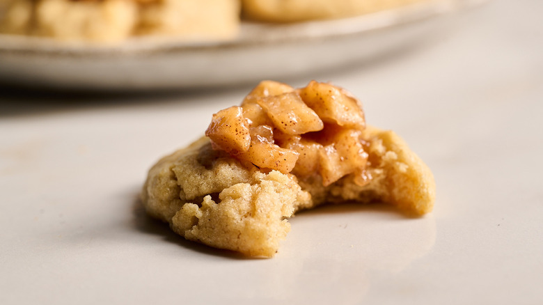 apple pie cookie with a bite on a table