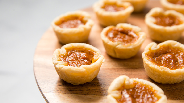 mini pumpkin pies on board