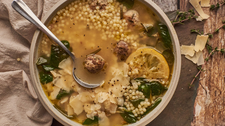 Bowl of rustic Italian wedding soup with meatballs