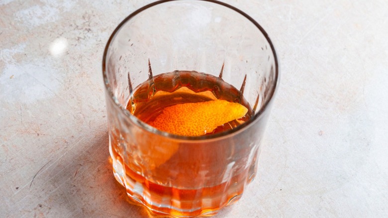 Sazerac cocktail in a glass with a lemon peel garnish