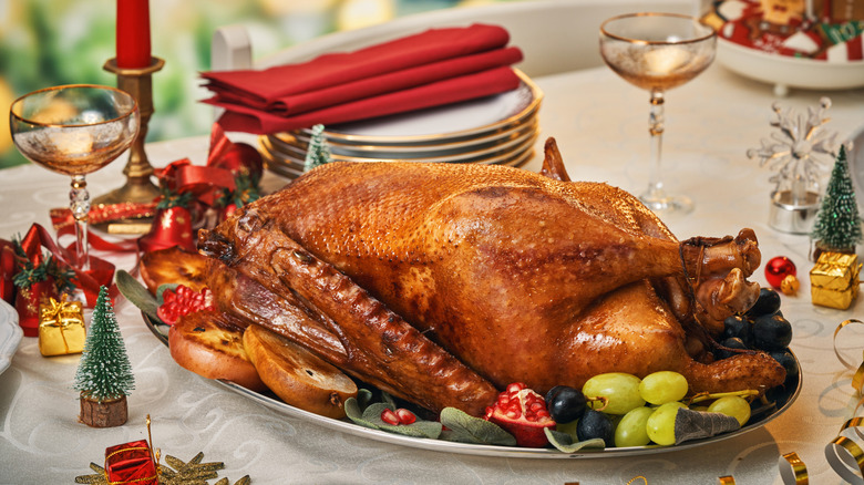 Roasted goose on a platter garnished with fresh fruit