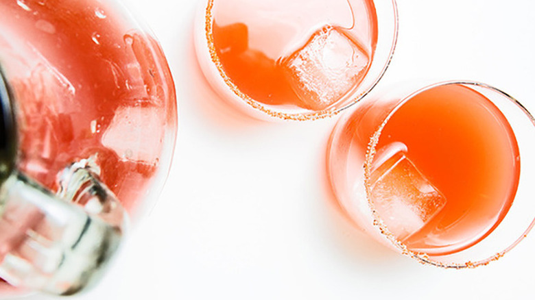 Top-down view of watermelon cocktails in glasses and a pitcher