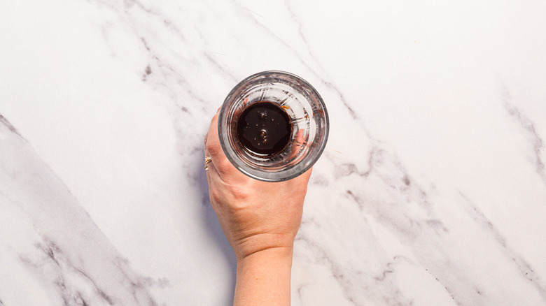 Holding glass with chocolate syrup