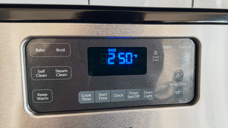 closeup of oven display showing preheating to 250 F