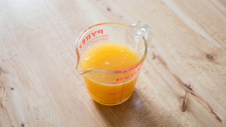 margarita mixture in measuring cup on wooden surface