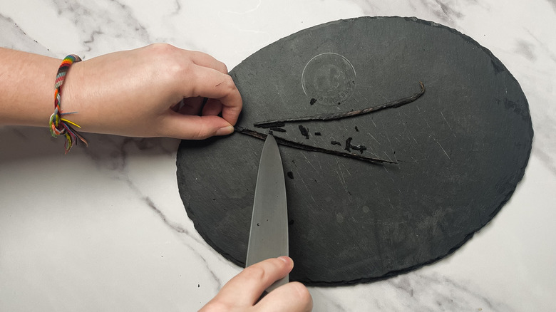 Scraping out the seeds from a vanilla pod