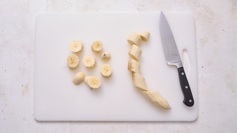 slicing banana on a cutting board