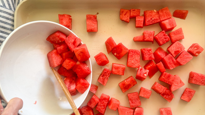 hand spreading out watermelon