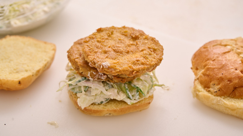building fried green tomato sandwich on table