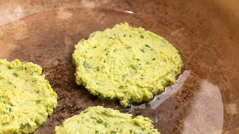 edamame fritters cooking in pan