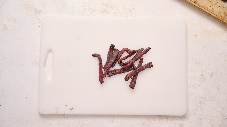 slices of beef jerky on a cutting board