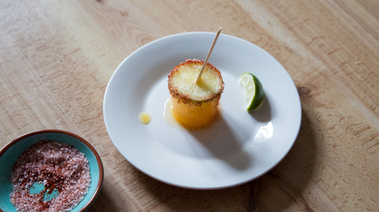 Garnished margarita popsicle and lime wedge on white plate