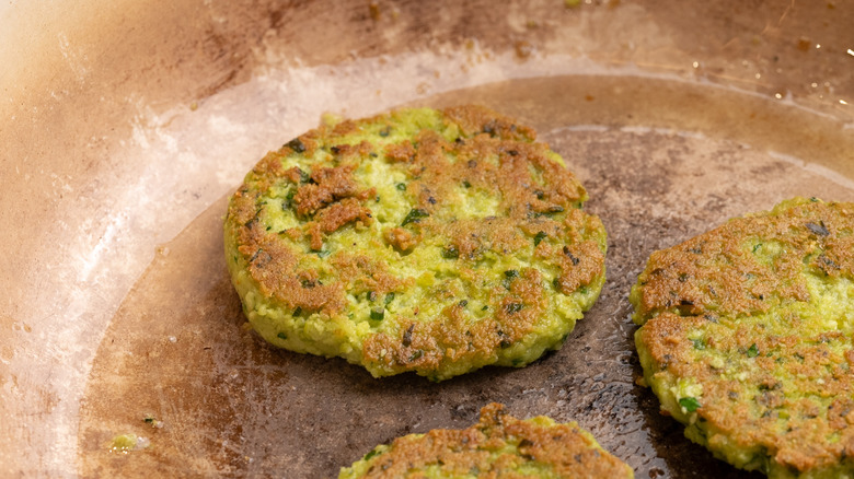 edamame fritters cooking in pan