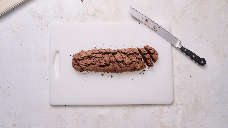 slicing biscotti on a cutting board