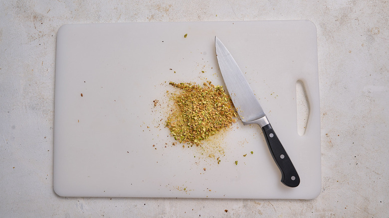 chopped pistachios on a cutting board